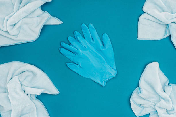 istock top view of rubber gloves and rags isolated on blue 939974048