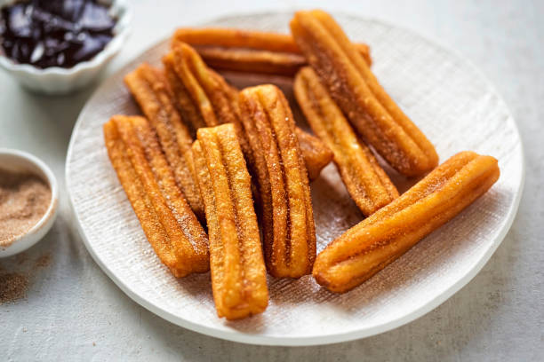 istock Churros with cinnamon sugar and chocolate sauce 939974326