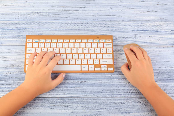 istock top view on female hands near wireless gold keyboard and mouse 939978800
