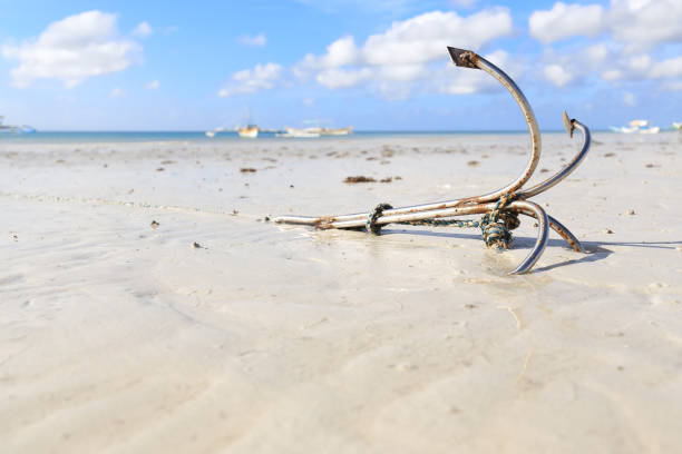 istock Anchor buried in the sand 939983268
