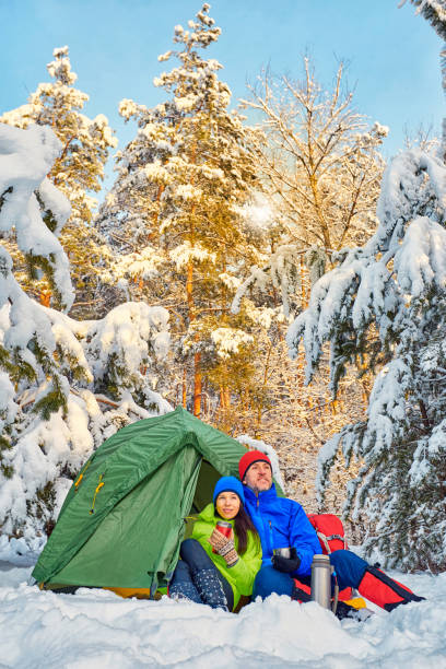 istock Walk through the winter forest with a backpack and tent. 939985624