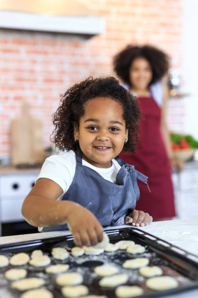 istock Little girl preparing biscuits at home 939986030