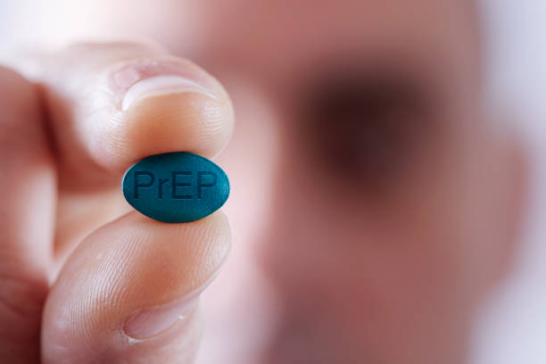 young man with a PrEP pill stock photo