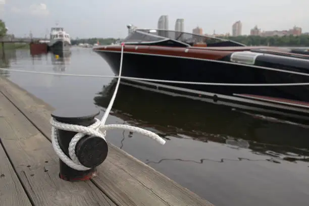 Luxury boat on a leash near the pier. Transport