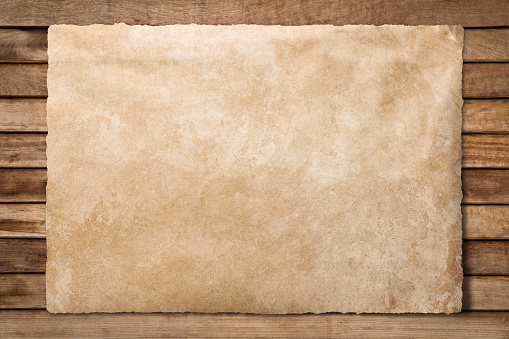 Old paper sheet at wooden background