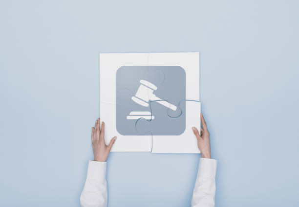 istock Woman completing a puzzle with a gavel icon 940011260