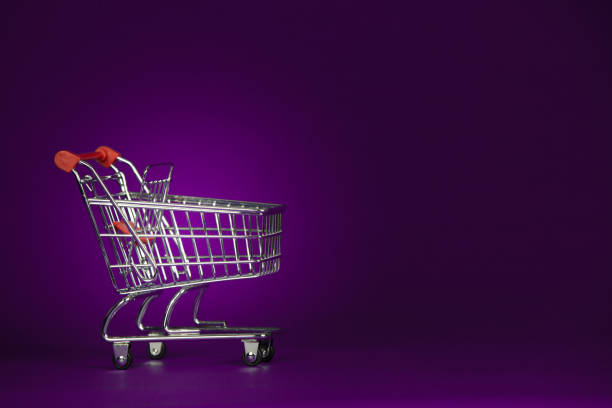 istock Shopping Cart Trolly on a Purple Background 940011444