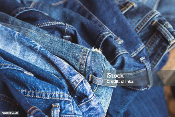 Jeans Scattered On A Wooden Background Stock Photo - Download Image Now - Jeans, Denim, Broken