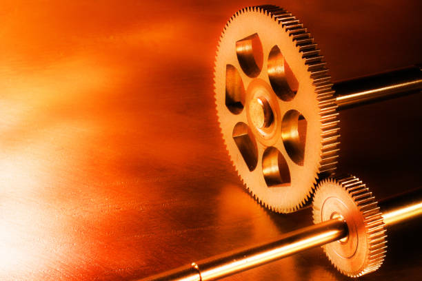 istock Two metal cogged wheels on steel background 940015618