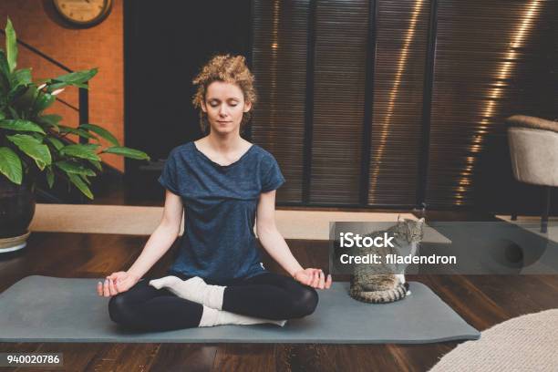 Practicing Yoga At Home Stock Photo - Download Image Now - Yoga, Meditating, Women