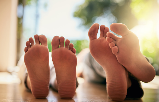 Closeup shot of an unrecognizable couple's bare feet