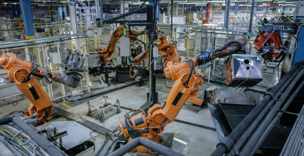 istock Industrial robotic arms performing operations 940024064