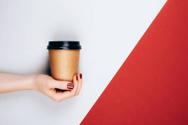 Hand with cup of coffee to go
