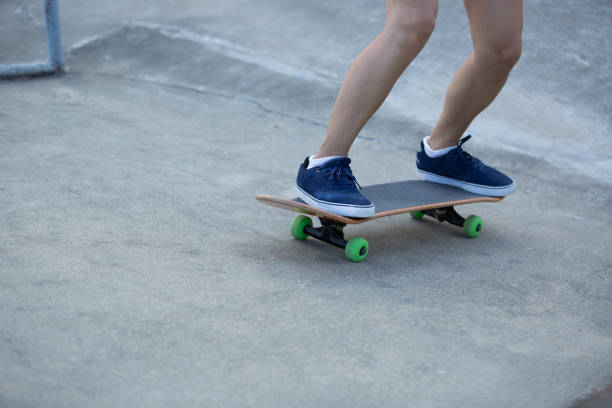 istock Skateboarder legs practicing on skatepark ramp 940030522