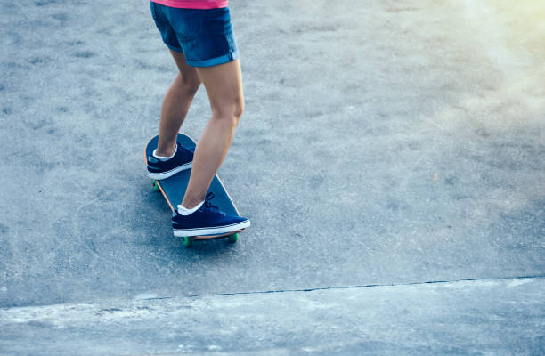 istock Skateboarder legs practicing on skatepark ramp 940030850