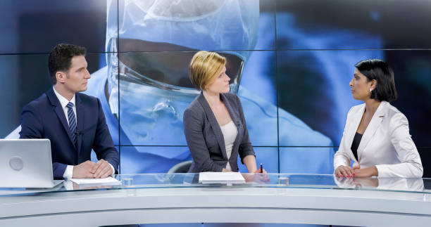 istock Journalists sitting with businesswoman 940035168