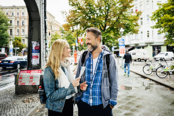 istock Tourist Couple Deciding Where To Go Using Leaflet 940035226