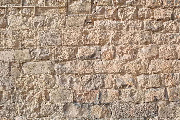 Photo of Ancient stone wall texture background. Gothic Quarter. Barcelona, Spain.