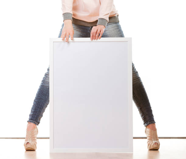 istock woman holding blank presentation board 940049394
