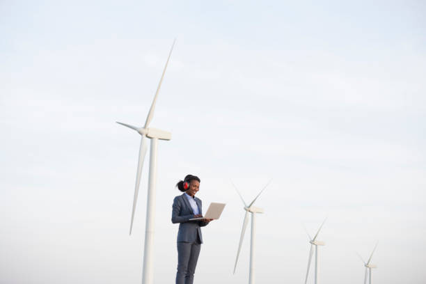 istock Sustainable energy engineer at wind turbines field. 940054242