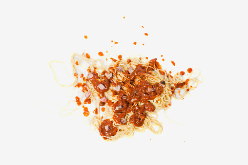 A fallen dish of pasta on the floor