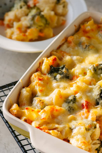 istock Close up of broccoli and pumpkin mac and cheese in a ceramic dish 940070106