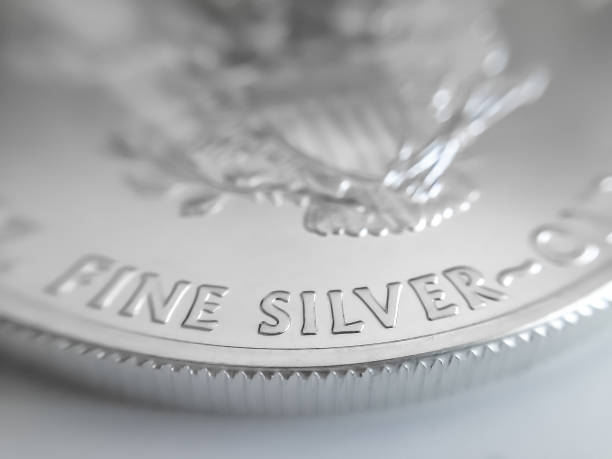 Macro close up of a pure Silver Bullion coin Used as a means of exchange and a store of value. The word silver and money are identical in some languages ingot photos stock pictures, royalty-free photos & images