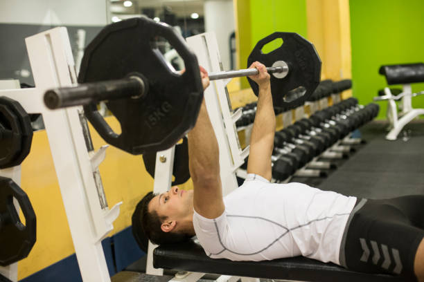 istock Young man exercising in gym 940070470