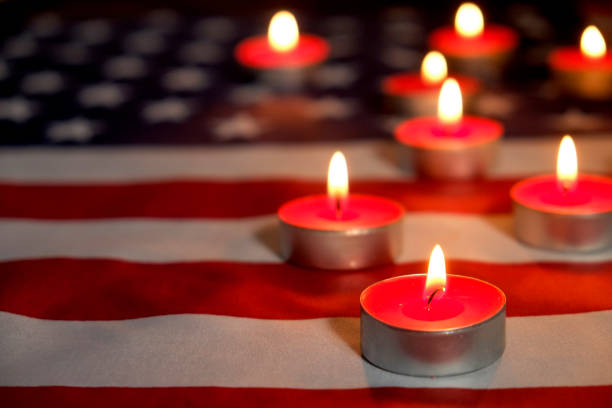 Background flag of the United States of America for national federal holidays celebration and mourning remembrance day. USA symbolics. Mourning candles burning on USA American national flag background. Memorial weekend, patriot veterans day, 9/11 National Day of Service & Remembrance. Moment of silence concept. Close up, copy space. moment of silence stock pictures, royalty-free photos & images