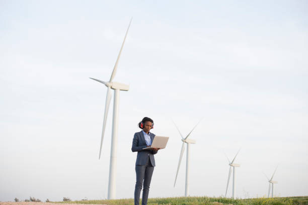 Renewable energy engineer woman at wind farm.