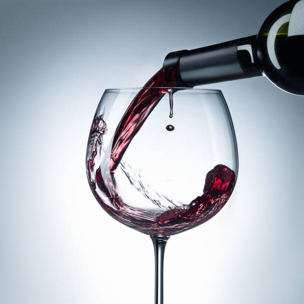 wine is pouring into glass - action alcohol alcoholism bar imagens e fotografias de stock