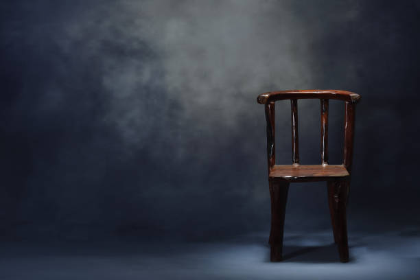istock Old wooden chair on dark scene 940078780