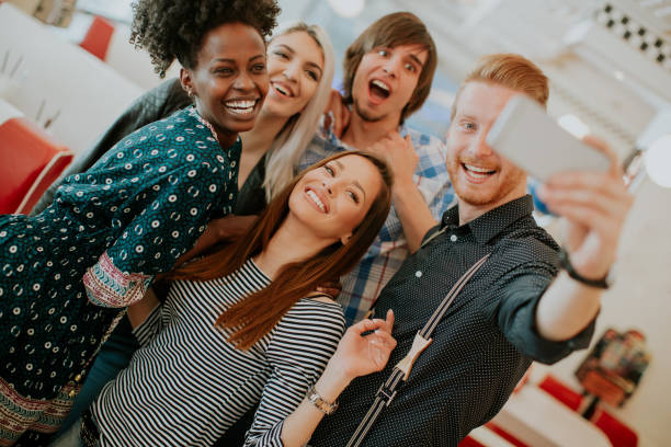 istock Group of young people taking selfie with mobile phone 940079080