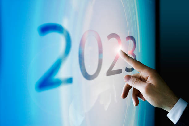 Businessman touching the screen about 2023