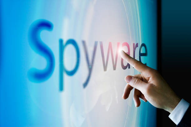 istock Businessman touching the screen about spyware 940090666