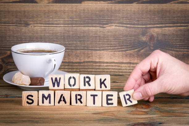 istock work smarter. Wooden letters on the office desk, informative and communication background 940096468