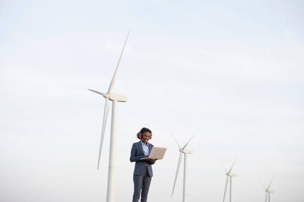 istock Renewable energy engineer woman at wind farm. 940099562