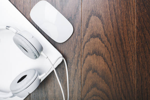 istock Headphones and device on wooden desktop 940099918