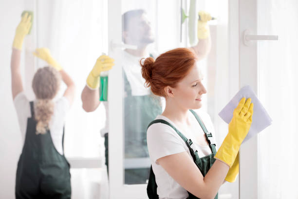 istock Woman cleaning window 940108636