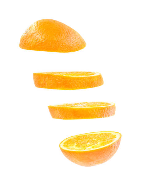 istock sliced flying orange isolated on white background. cut orange in pieces isolated on white background. Levity fruit floating in the air. 940114448