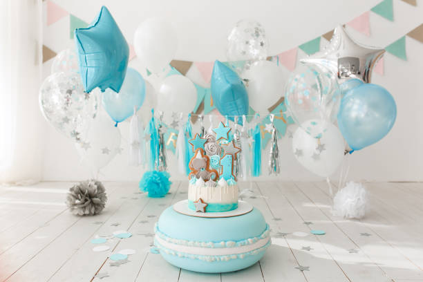 istock First birthday decorated room with blue cake standing on big macaroon 940114722