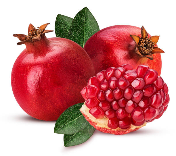 istock Two ripe pomegranate fruit and slice with leaf isolated on white 940118264