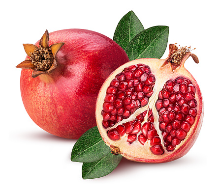 Ripe pomegranate fruit and one cut in half with leaf isolated on white background. Clipping Path. Full depth of field.