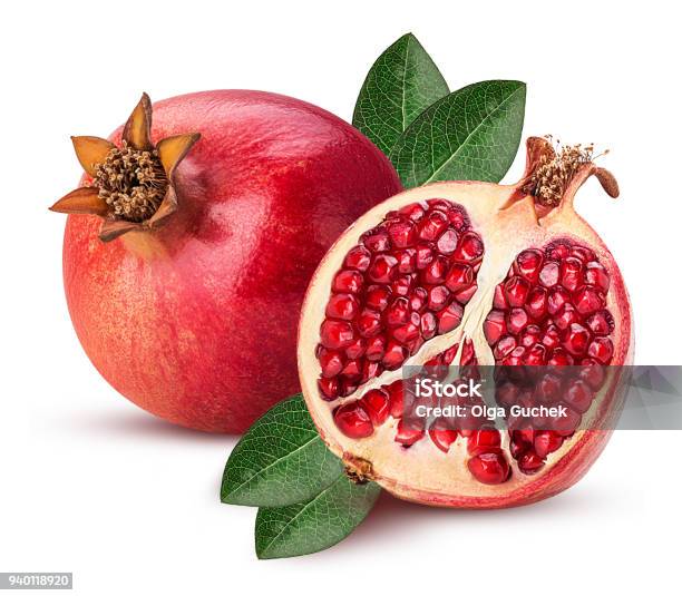 Ripe Pomegranate Fruit And One Cut In Half With Leaf Stock Photo - Download Image Now