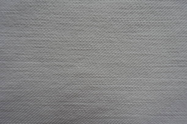istock Closeup of white denim fabric from above 940132224