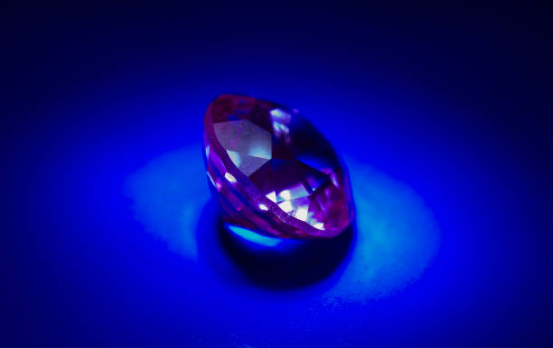 istock Pink sapphire on a blue background in light 940140636