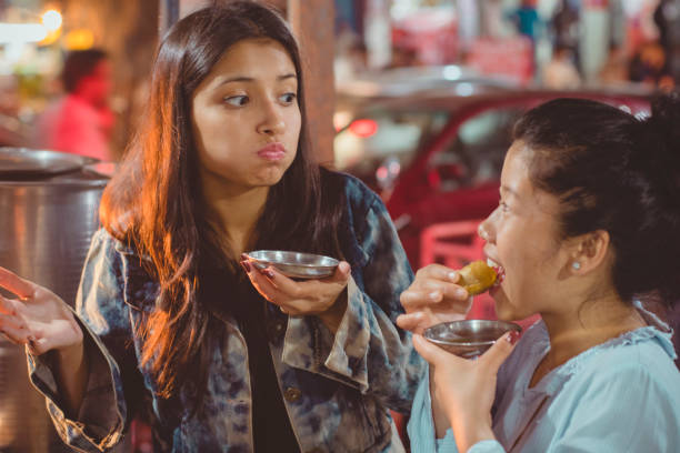 istock Multiethnic female friends eating pani puri. 940142874