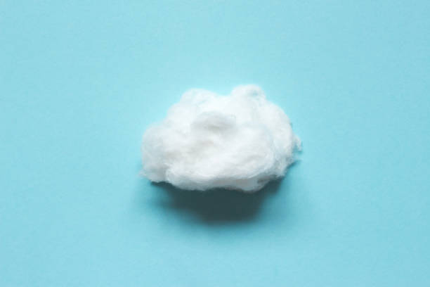 Fluffy soft cloud from cotton wool on blue background. Fluffy soft cloud from cotton wool on blue background. cotton cloud stock pictures, royalty-free photos & images