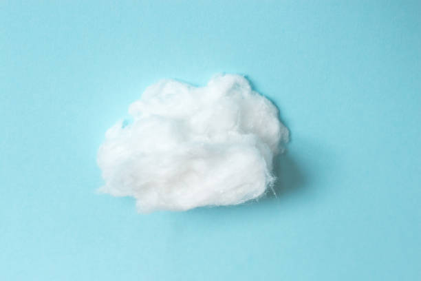 istock Fluffy soft cloud from cotton wool on blue background. Healthcare. 940143944