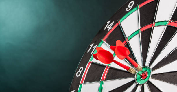 zwei pfeile in der mitte des ziels dartboards - target dartboard bulls eye dart stock-fotos und bilder